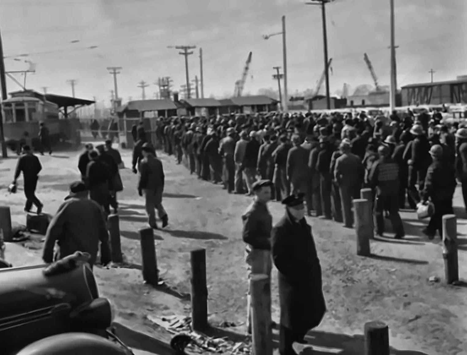 Shift workers queueing at the Bethlehem Fairfield shipyard gate, 1943. A message from Snags in Slack to Tom: four people are waiting for the Q4 numbers.